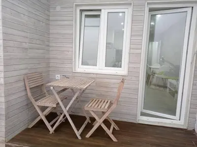 a wooden table and two chairs next to a window at Torre dos Clérigos Apartment in Porto