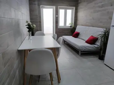 a room with a table and chairs and a couch at Torre dos Clérigos Apartment in Porto