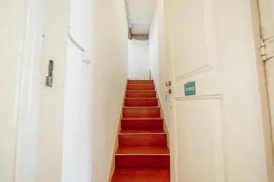 a stairway with red stairs and a white door at Moinho de Vento Studios in Porto