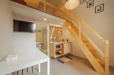 a loft conversion with a staircase in a room at Moinho de Vento Studios in Porto