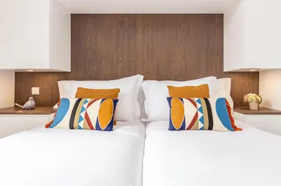 two beds sitting next to each other in a room at OPO Vale Formoso II Garden & BBQ in Porto