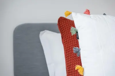 a white pillow with butterflies on top of it at GuestReady - Freixo Paradise view in Porto