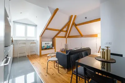 a living room with a table and a dining room at GuestReady - Freixo Paradise view in Porto