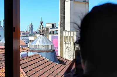 a white bedroom with a bed and two windows at Plano C 2 Oporto Downtown in Porto