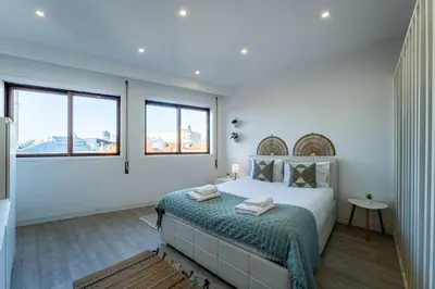 a bedroom with a bed with a blue light at Plano C 2 Oporto Downtown in Porto