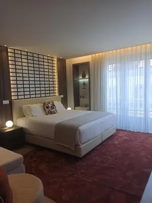 a bedroom with a large bed and a large window at BrandApartments in Porto