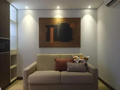 a couch in a living room with a painting on the wall at BrandApartments in Porto