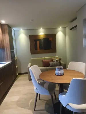 a room with a table and chairs and a couch at BrandApartments in Porto