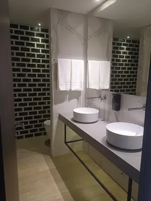 a bathroom with two sinks on a counter at BrandApartments in Porto