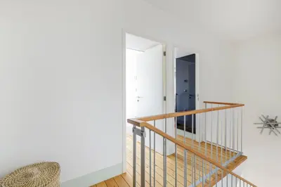a staircase leading to the second floor of a house at Design Poveiros Duplex in Porto