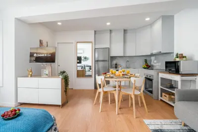 a kitchen and dining room with a table and chairs at Host Wise - Comfy Sunny Flat - Prime Location in Porto