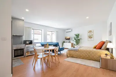 a bedroom with a bed and a table and chairs at Host Wise - Comfy Sunny Flat - Prime Location in Porto