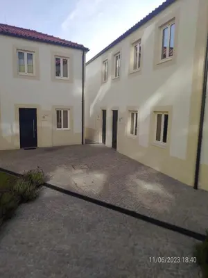 an empty parking lot in front of two buildings at 24 Porto Novíssímo Estudio em Cedofeita AC Olive in Porto