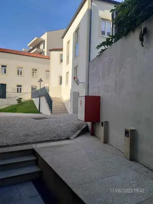 a red refrigerator sitting on the side of a building at 24 Porto Novíssímo Estudio em Cedofeita AC Olive in Porto