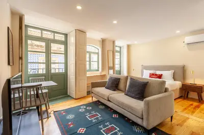 a living room with a couch and a bed at Dasi House in Porto