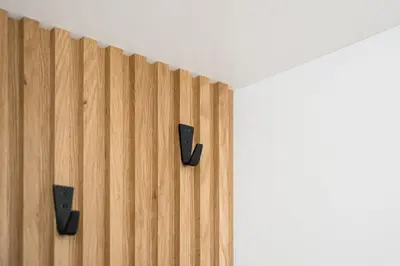 a wooden wall with two black speakers on it at GuestReady - Casa da Música Cosmopolitan Comfort in Porto
