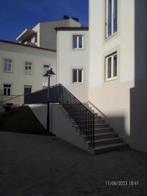 a building with a staircase in front of a building at 25 Porto Novíssímo Estudio em Cedofeita AC Olive in Porto