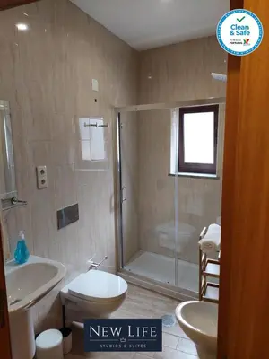 a bathroom with a shower and a toilet and a sink at New Life - TORRE CLÉRIGOS STUDIO-3T in Porto