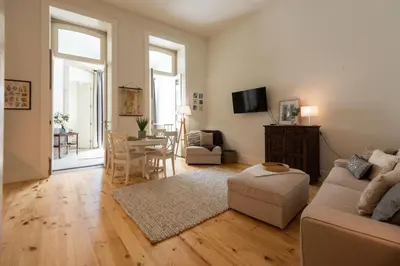 a living room with a couch and a table at Porto Grandeur Collection - D. João IV Pool & Garden Apartment in Porto