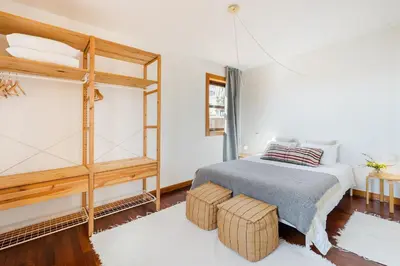 a bedroom with a bed and a loft bed with two ottomans at Hey Apartments A in Porto