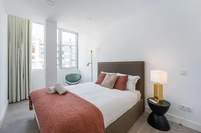 a bedroom with a bed with a red blanket at GuestReady - Sedona lodge near Palácio de Cristal in Porto