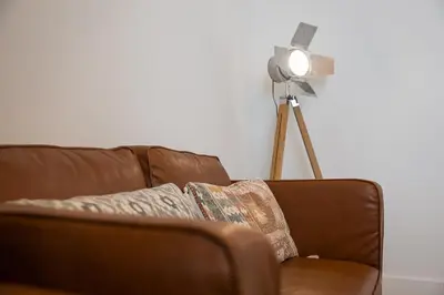 a brown couch with a fan in a living room at GuestReady - Sedona lodge near Palácio de Cristal in Porto