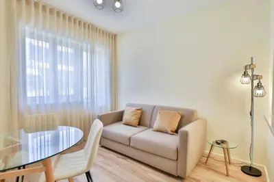 a living room with a couch and a glass table at Antero sweet & cozy apartment by PCH in Porto