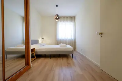 a small bedroom with a bed and a mirror at Antero sweet & cozy apartment by PCH in Porto