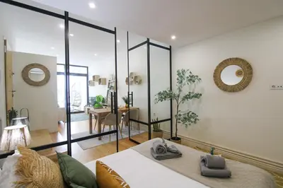 a bedroom with a bed and a large glass wall at La Vida in Porto Unique in Porto