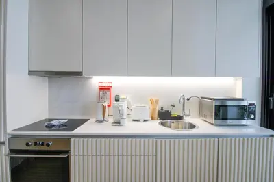 a kitchen counter with a sink and a microwave at La Vida in Porto Unique in Porto