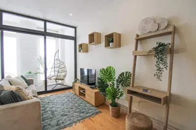 a living room with a couch and a window at La Vida in Porto Unique in Porto