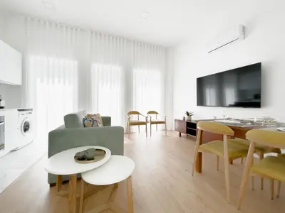 a living room with a couch and a table at Vibrant Host-Campo 24 Agosto in Porto