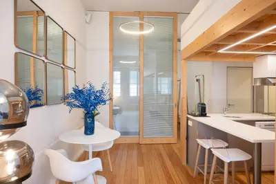 a kitchen with a vase of flowers on a table at Sao Domingos Stylish Apartment in Porto