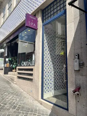 a store front with a purple sign on the door at Sao Domingos Stylish Apartment in Porto