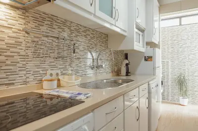 a kitchen with a sink and a brick wall at Bright Apartment by Hosty in Porto