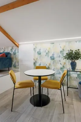 a table and four chairs in a room at HM - Home Feeling Studio Campanhã in Porto