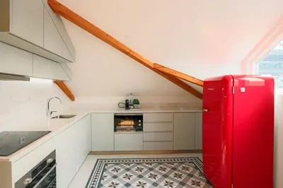 a kitchen with a red refrigerator in a room at HM - Home Feeling Studio Campanhã in Porto