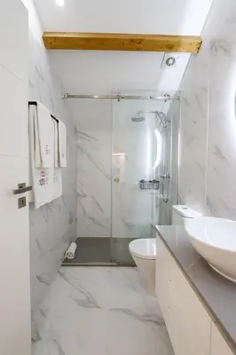 a bathroom with a shower and a toilet and a sink at HM - Home Feeling Studio Campanhã in Porto