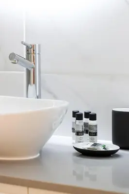 a bathroom counter with a sink and a white bowl at HM - Home Feeling Studio Campanhã in Porto