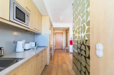 a kitchen with a sink and a microwave at S1405 - practical and modern - AC, balcony and parking in Porto