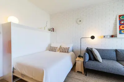 a bedroom with a bed and a couch at S1405 - practical and modern - AC, balcony and parking in Porto