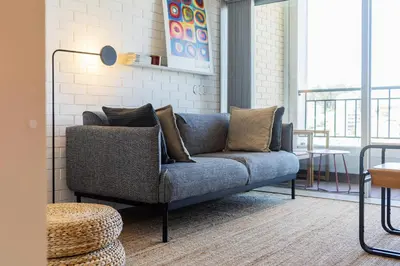 a living room with a blue couch and a table at S1405 - practical and modern - AC, balcony and parking in Porto