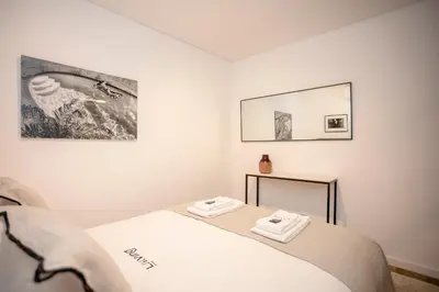 a bedroom with a bed with two towels on it at Liiiving in Gaia - Cooper Residence Apartment II in Vila Nova de Gaia