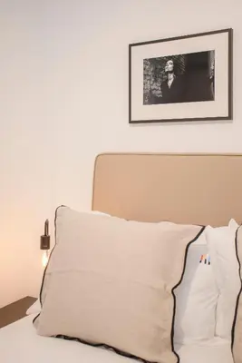 a bed with a white pillow and a picture on the wall at Liiiving in Gaia - Cooper Residence Apartment II in Vila Nova de Gaia