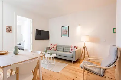 a living room with a couch and a table at Cozy and Homely Getaway by LovelyStay in Porto