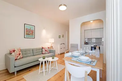 a living room with a couch and a table at Cozy and Homely Getaway by LovelyStay in Porto