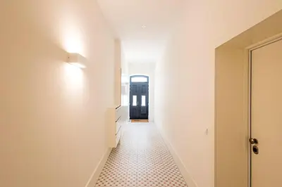 a hallway with white walls and a tile floor at Cozy and Homely Getaway by LovelyStay in Porto