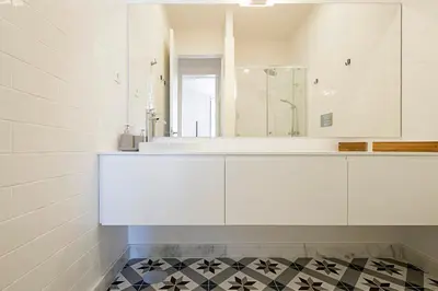 a white bathroom with a sink and a mirror at Cozy and Homely Getaway by LovelyStay in Porto