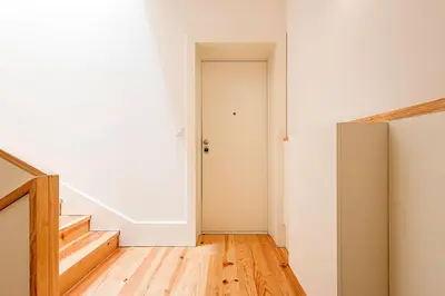 an empty room with a door and a hallway with wooden floors at Cozy and Homely Getaway by LovelyStay in Porto