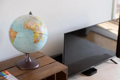 a globe sitting on a table next to a television at The Flat in Porto